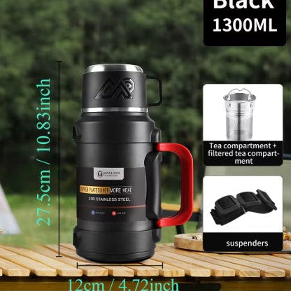 Compact 1300ml Frostbear Flask thermos bottle in matte black, made from stainless steel with multi-layer vacuum insulation that keeps drinks hot or cold for up to 72 hours. Features a built-in tea filter, folding handle, and adjustable carry strap — perfect for camping, hiking, and outdoor adventures.