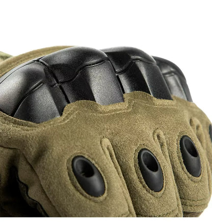 Close-up view of green Windwarden Tactical Glove showing molded knuckle guard and vent holes — designed for impact protection and ventilation during tactical operations.